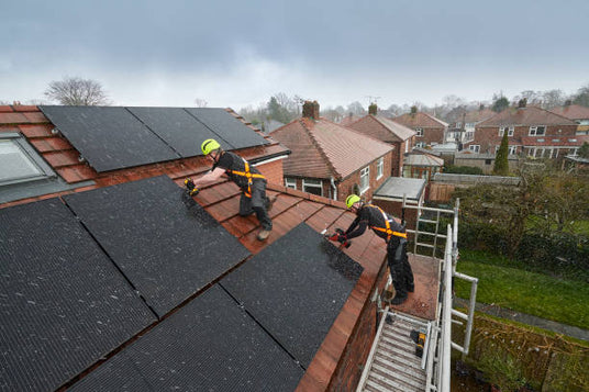 Worker installing rooftop solar in uk - residential solar installation